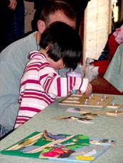 A child works on a puzzle during Spring Pre-School Train 2007